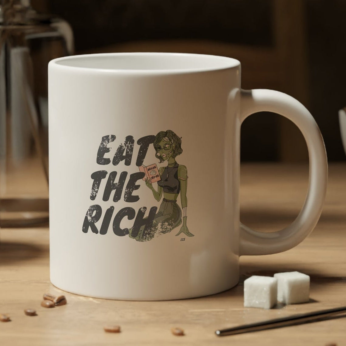 White mug with a skull wearing a cowboy hat and holding a coffee cup design, placed on a wooden table with coffee beans and a jar of coffee.