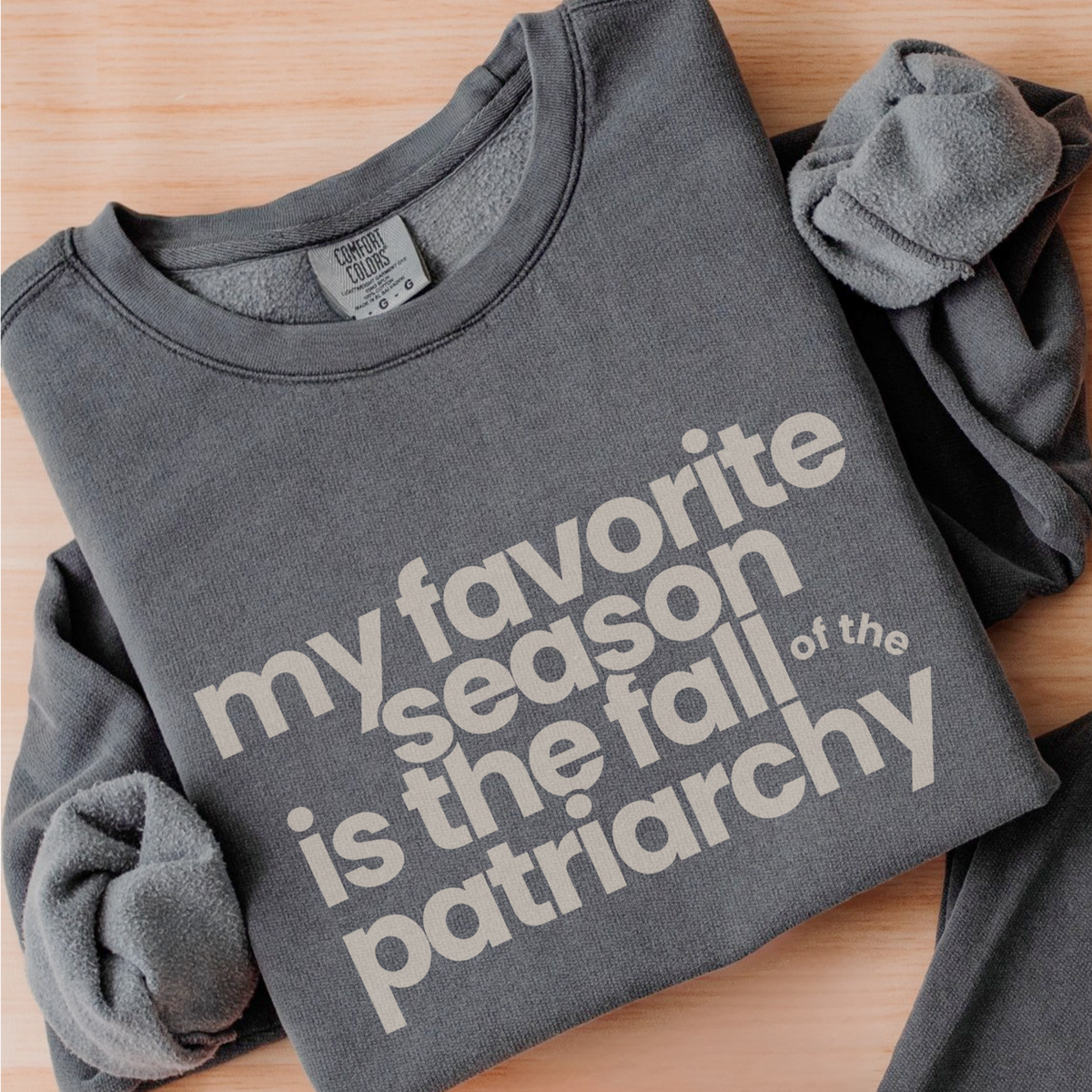 My Favorite Season Is the Fall of the Patriarchy sweatshirt featuring funny feminist fall artwork on a cozy graphic crewneck for autumn style.