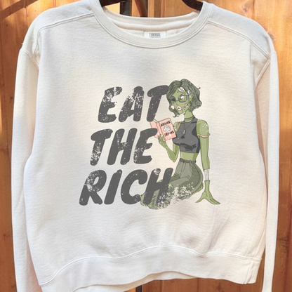 Eat the Rich zombie Halloween sweatshirt with feminist political satire graphic, relaxed cropped fit, and cozy fleece interior for spooky season.