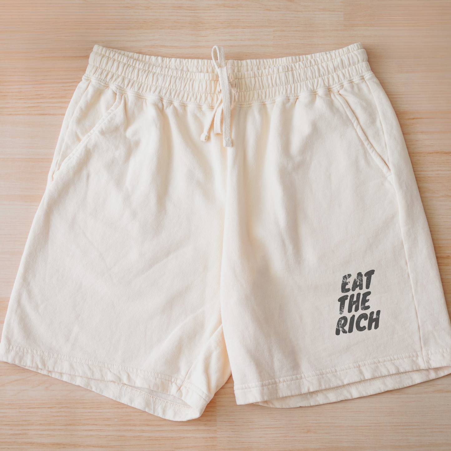 Eat the Rich zombie Halloween sweat shorts featuring feminist political satire artwork, soft fleece, drawstring waist, and spooky season style.