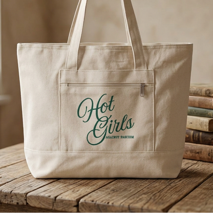 Hot Girls Against Fascism feminist canvas tote bag with zipper closure, exterior pocket, roomy book storage, and bold activist political design.