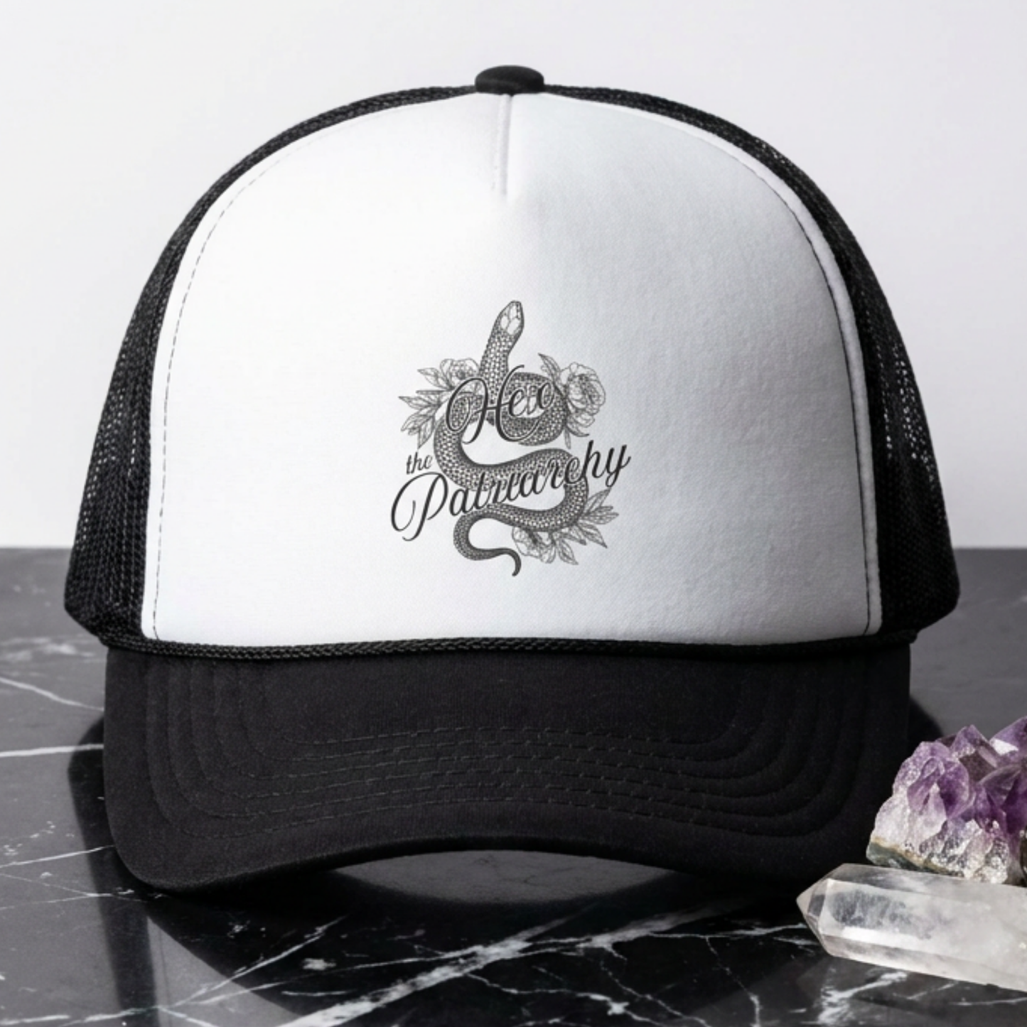 Hex the Patriarchy snake trucker hat featuring feminist witchy artwork, classic mesh-back styling, and symbolic snake design.