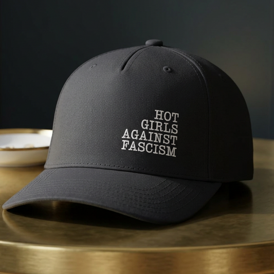 Hot Girls Against Fascism black baseball cap with white embroidered feminist design, structured mid-profile crown, green brim, and adjustable snap closure.