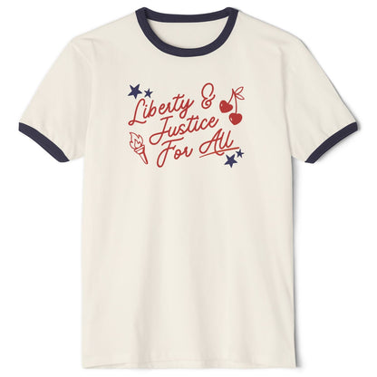 An off-white ringer t-shirt with navy blue trim on the collar and sleeves, featuring a red and blue graphic on the chest that reads 'Liberty & Justice For All' with stars, cherries, and a torch.