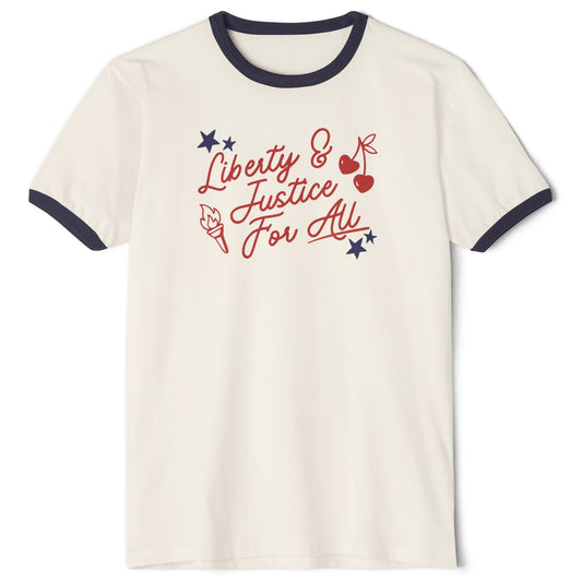 An off-white ringer t-shirt with navy blue trim on the collar and sleeves, featuring a red and blue graphic on the chest that reads 'Liberty & Justice For All' with stars, cherries, and a torch.