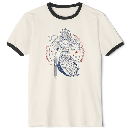 An off-white ringer t-shirt with black trim on the collar and sleeves, featuring a central  red, white, and blue graphic of a female warrior holding a sword and shield, surrounded by red stars and circular text that reads: “Injustice anywhere threatens justice everywhere”