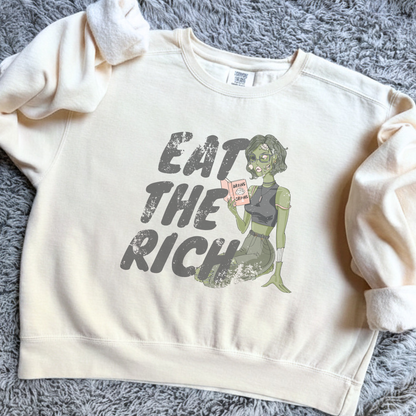 Eat the Rich zombie Halloween sweatshirt with feminist political satire graphic, relaxed cropped fit, and cozy fleece interior for spooky season.