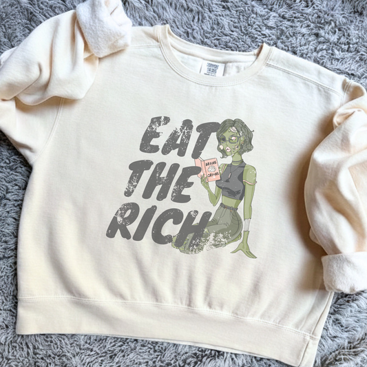 Eat the Rich zombie Halloween sweatshirt with feminist political satire graphic, relaxed cropped fit, and cozy fleece interior for spooky season.