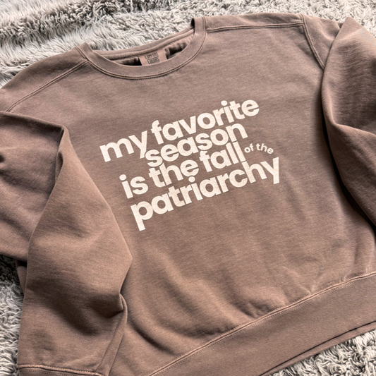 My Favorite Season Is the Fall of the Patriarchy sweatshirt featuring funny feminist fall artwork on a cozy graphic crewneck for autumn style.