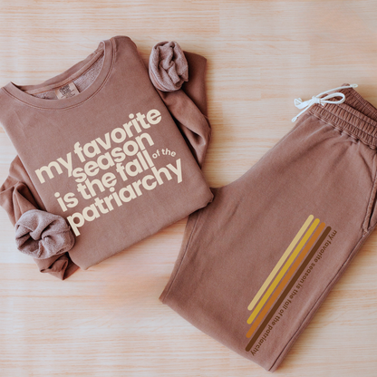 My Favorite Season Is the Fall of the Patriarchy sweatshirt featuring funny feminist fall artwork on a cozy graphic crewneck for autumn style.